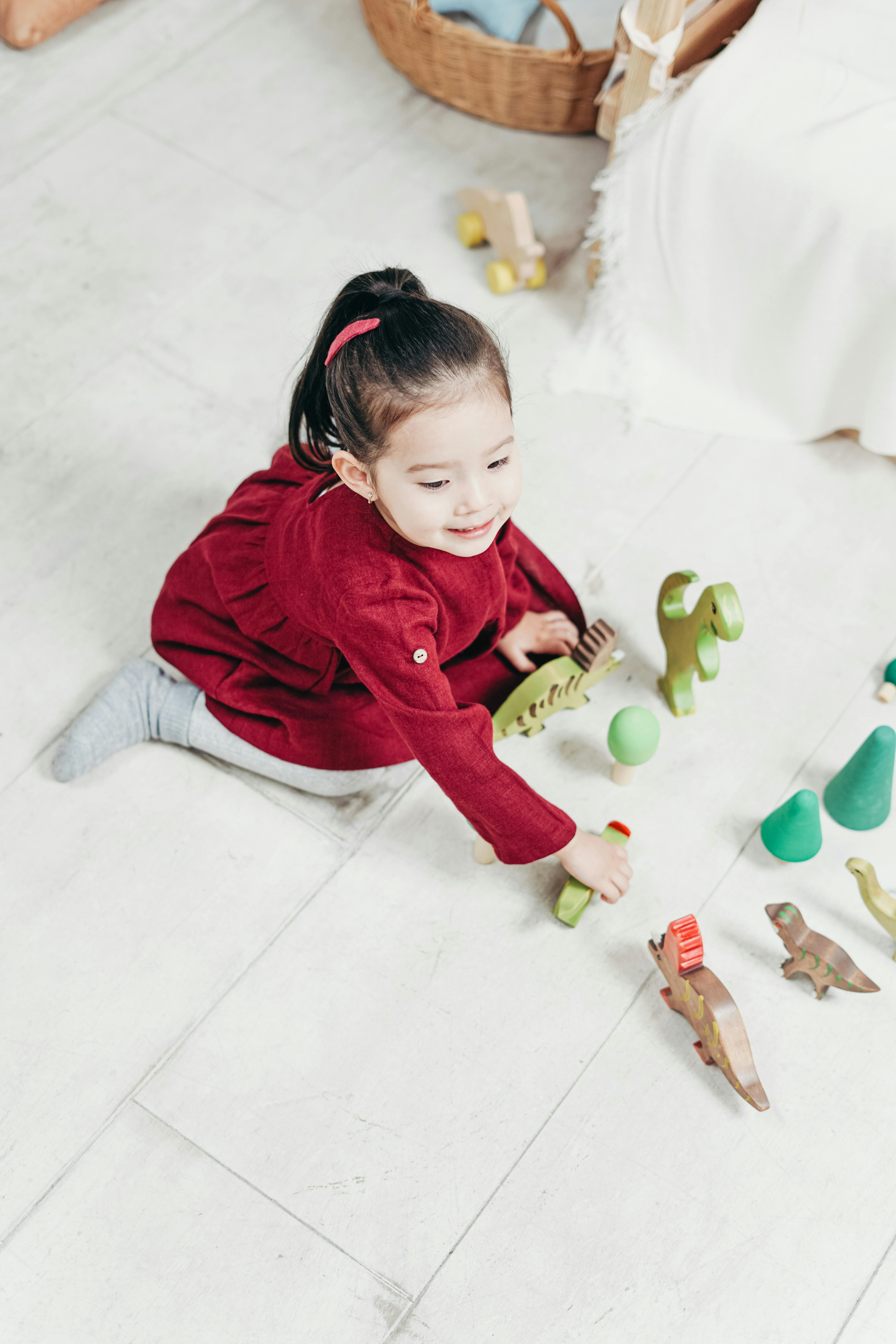 Young child smiling during an in-home ABA therapy session with an AAC communication device